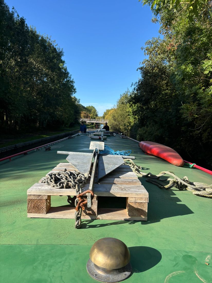Anchor and chain stowed on the bow deck, looking aft along the boat