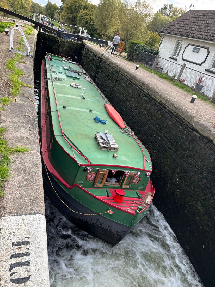 The boat descending through a lock, seen from above