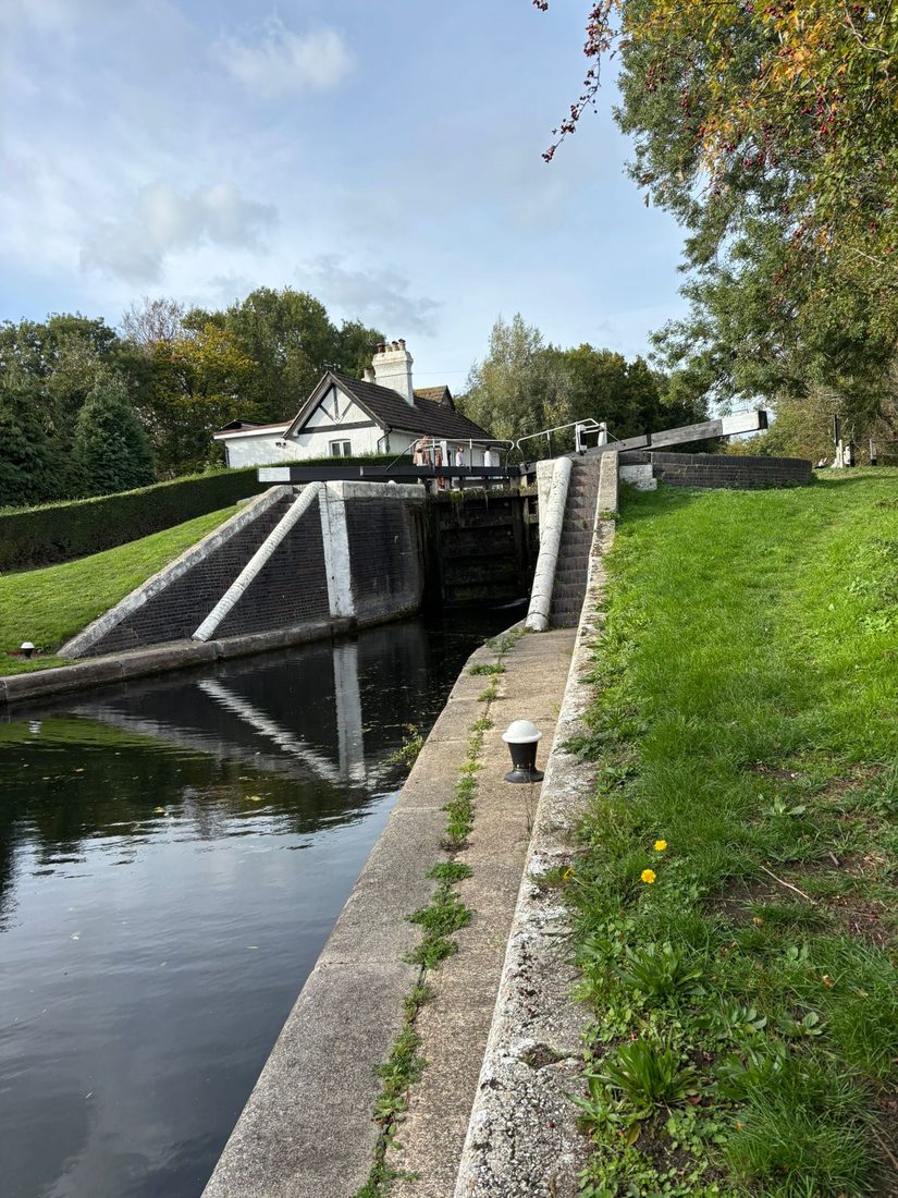 A canal lock with a lock-keeper's cottage behind it